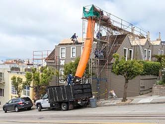 Workers next to scaffolding