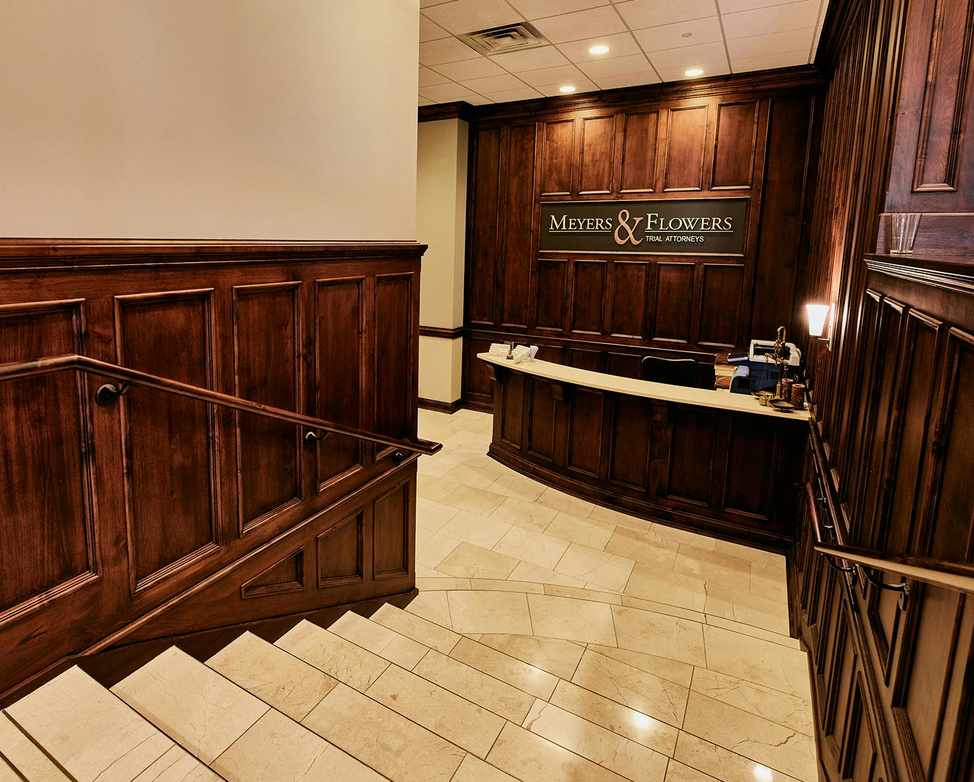 there is a large wooden wall in the lobby of a building