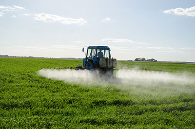 tractor spraying a field