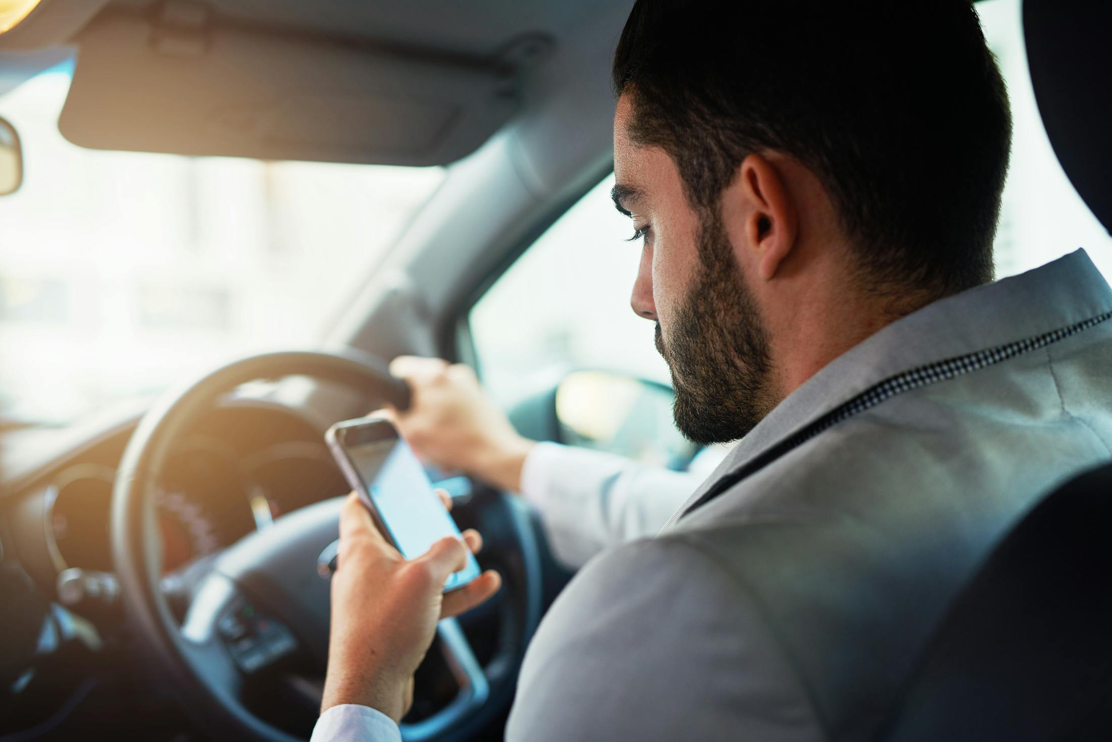 Man driving and texting