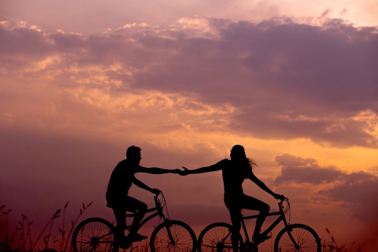 Couples on bikes Glasgow at sunset