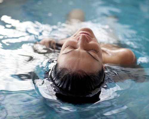 Woman Relaxing in Swimming Pool