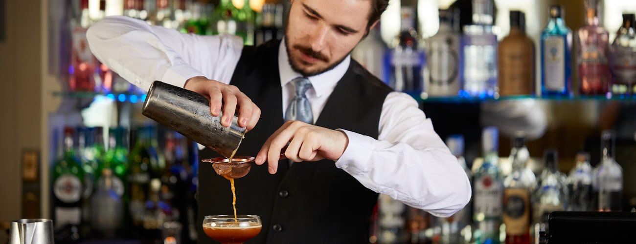Bar Man pouring Cocktails