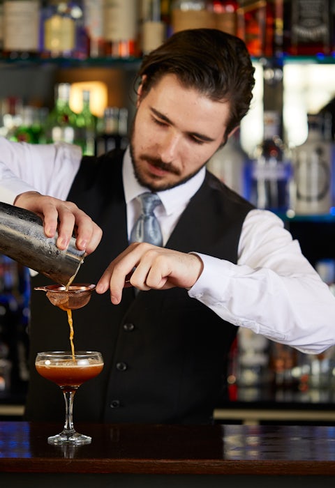 Bar Man pouring Cocktails