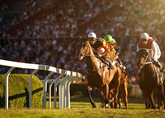 Horses and jockeys racing