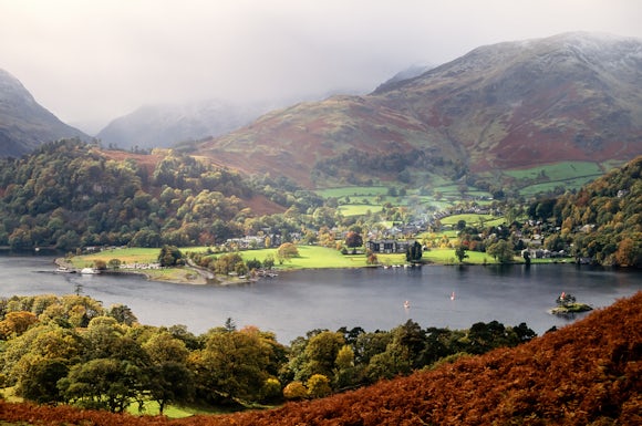 The Cumbrian village of Glenridding nestled in a valley between the shores of Ullswater and mountains behind, English Lake District, Cumbria, UK