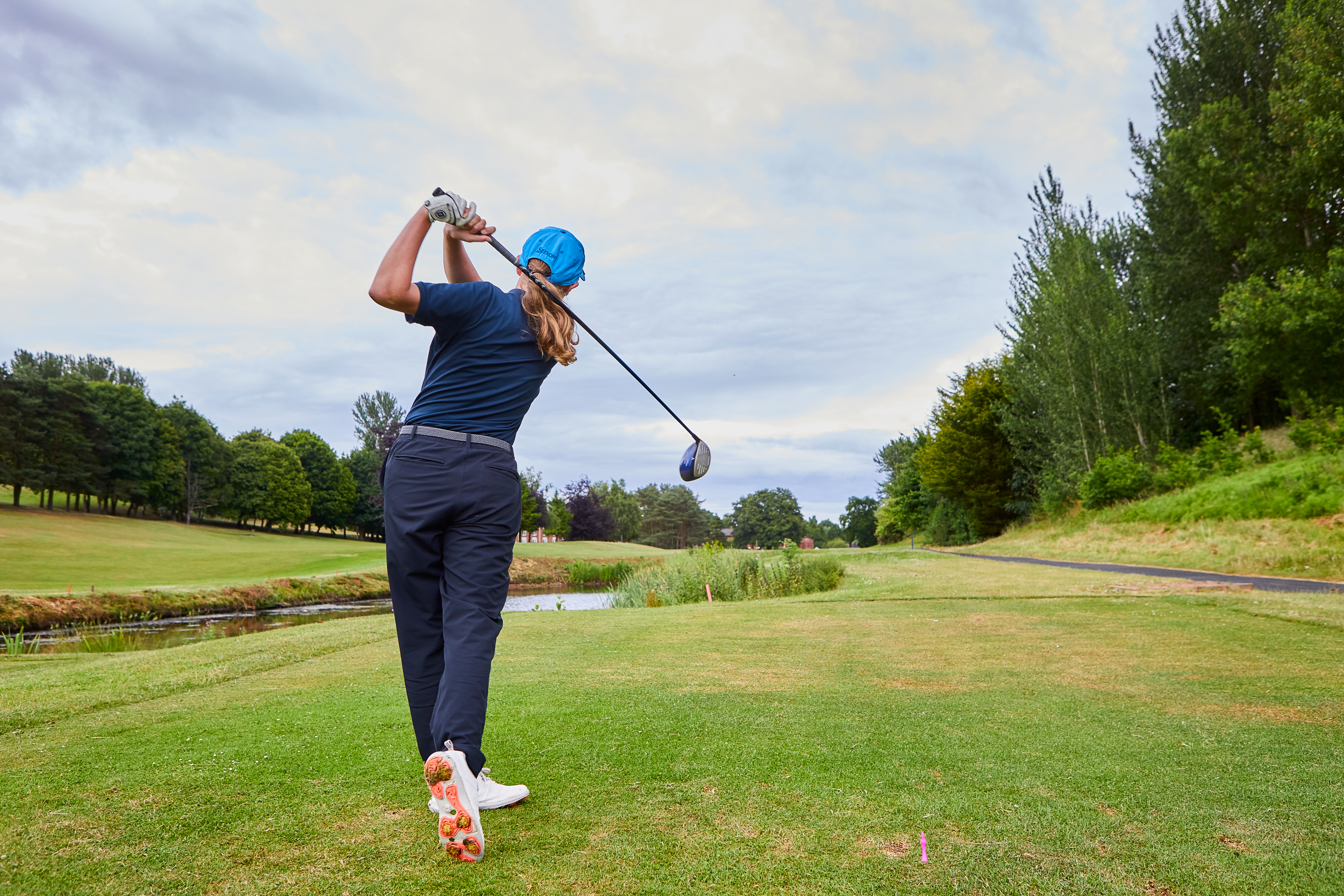 Young golfer driving at Hill Valley
