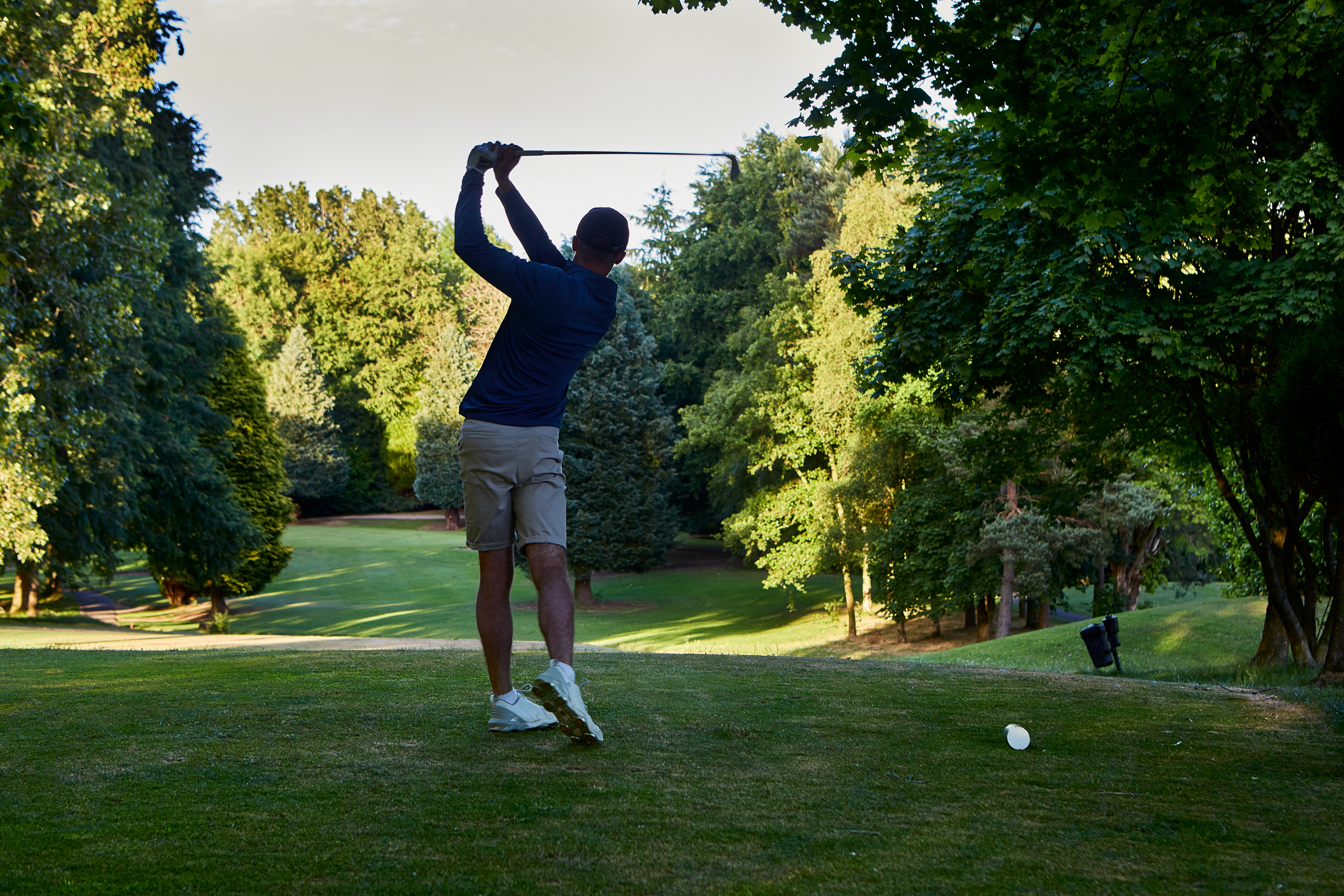 Golfer hitting the ball of the tee