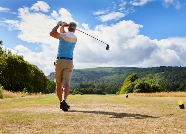 Golfer teeing off at Cardrona
