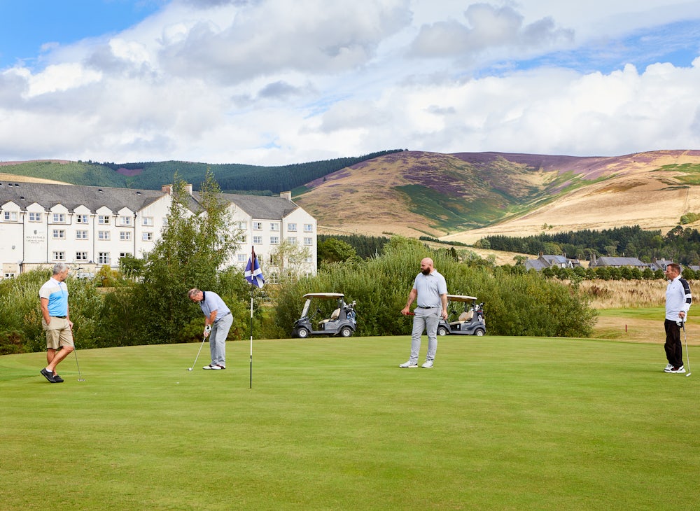 Golfers at Cardrona Golfer putting at Cardrona