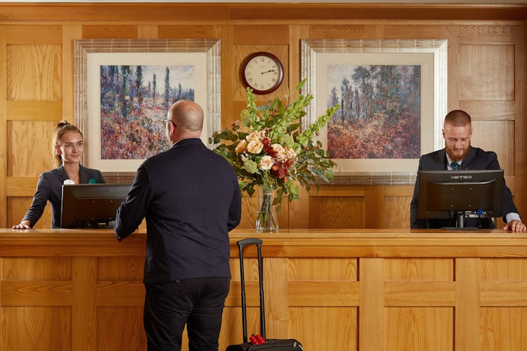 Guest checking into reception at Cardrona