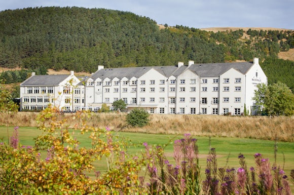 Cardrona Hotel surrounded by trees and the golf course