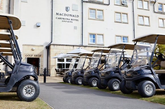 Golf buggies lined up outside the hotel