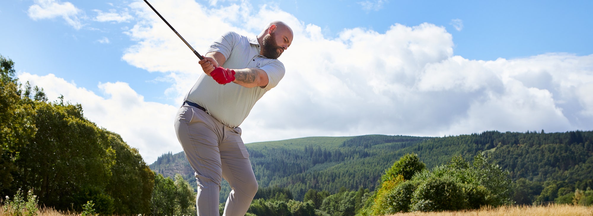 Golfers at Cardrona Golfer driving at Cardrona