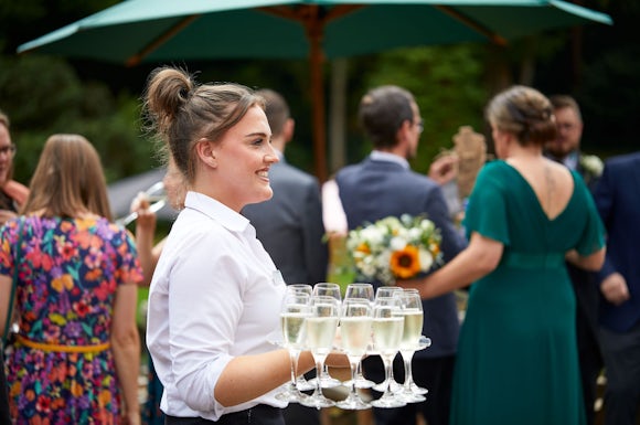 Frimley Hall Wedding Staff Serving Champagne
