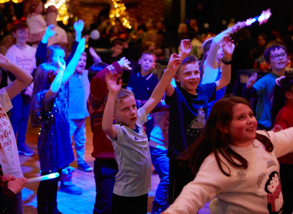 children dancing at a christmas party