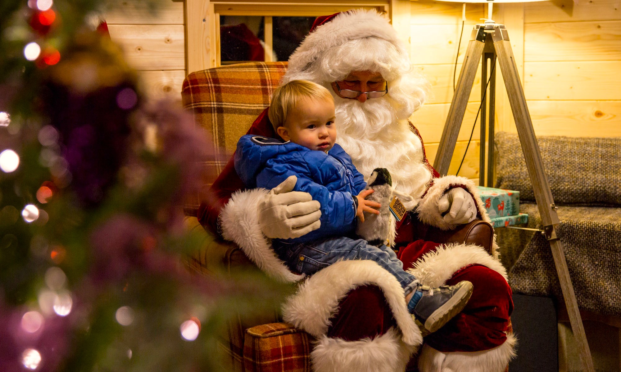 Santa meets a young guest in his Aviemore grotto