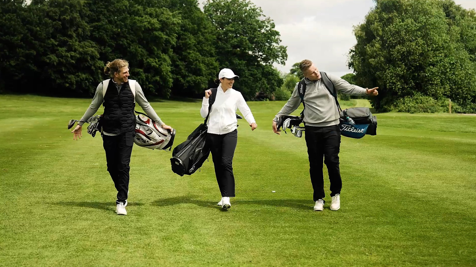 Three golfers walk the fairway at Portal