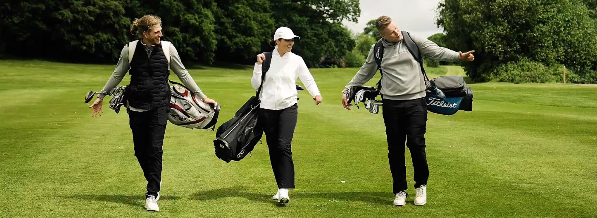 Three golfers walk the fairway at Portal Three golfers walk the fairway at Portal