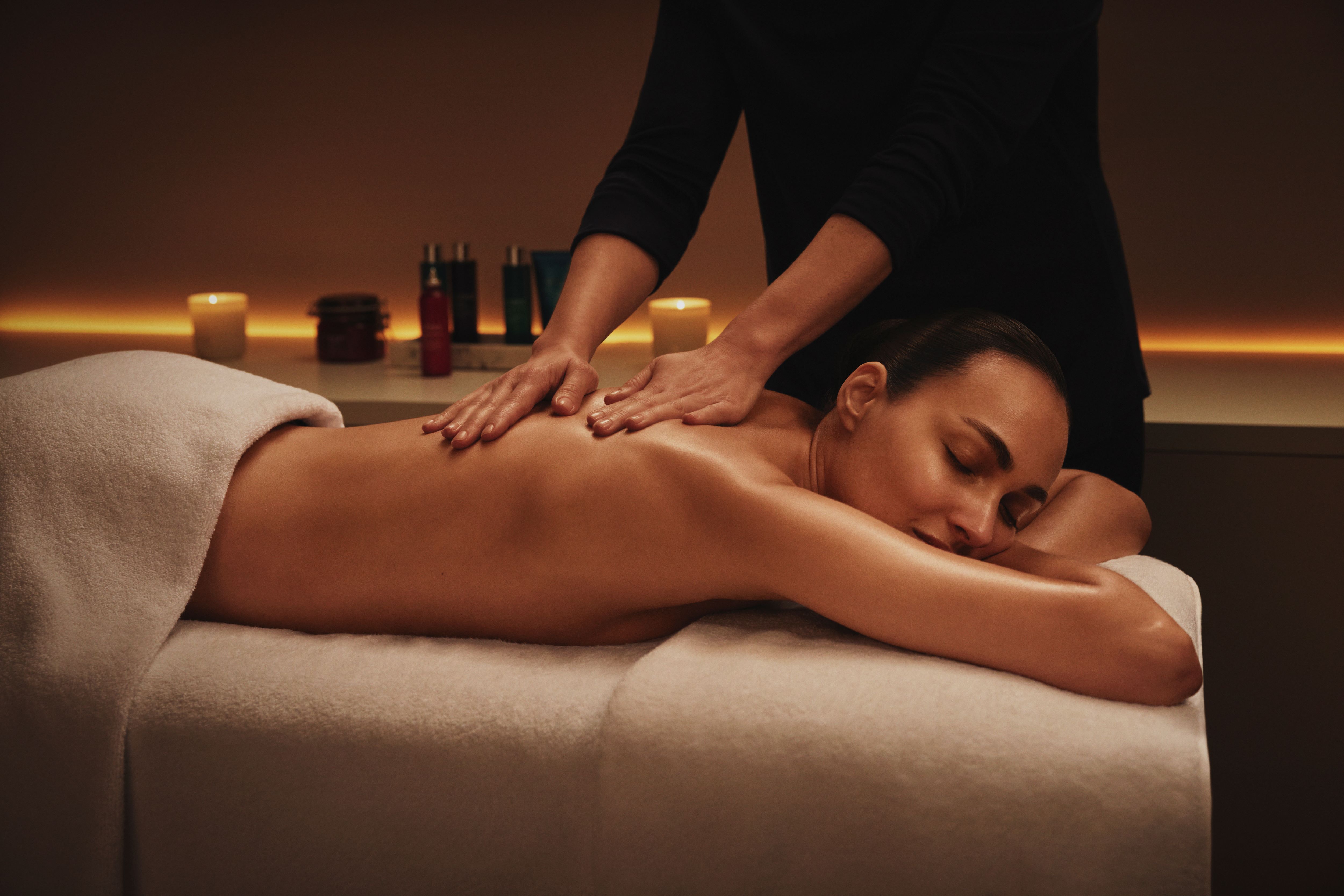 A woman enjoys a back massage