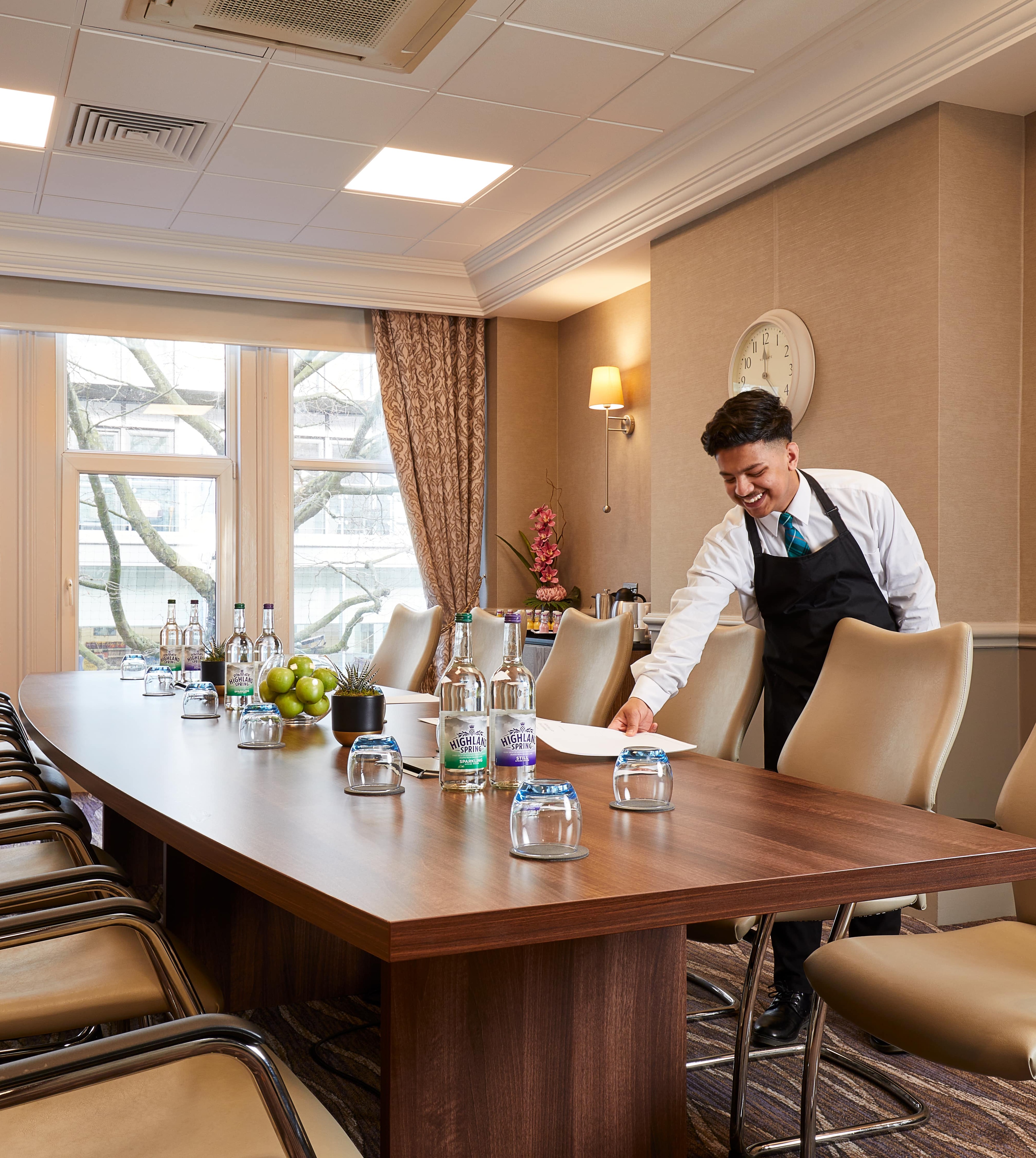 Meeting room layout and staff member at Burlington