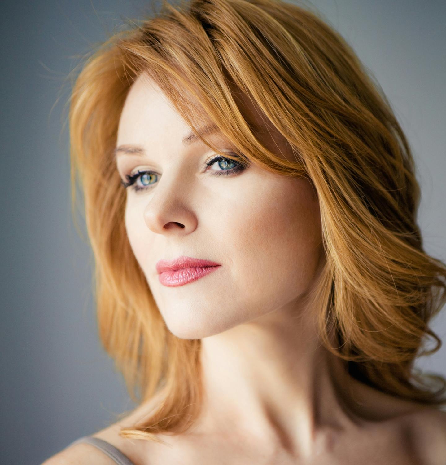 there is a woman with red hair and a gray top
