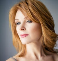 there is a woman with red hair and a gray top