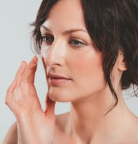woman about to touch face