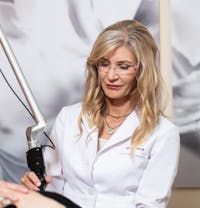 blond woman getting a haircut at a salon with a professional hair stylist