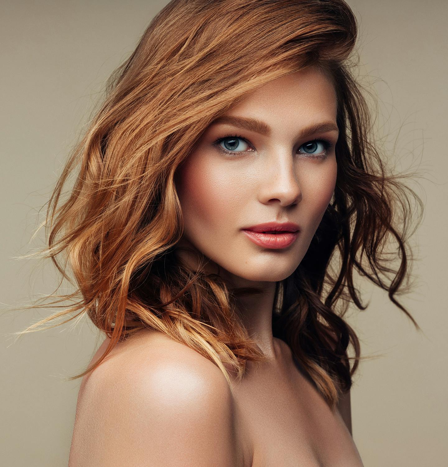 woman with red hair and blue eyes posing for a picture
