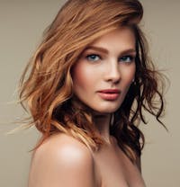 woman with red hair and blue eyes posing for a picture