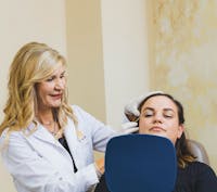 Dr. Jill Hazen showing woman face in mirror