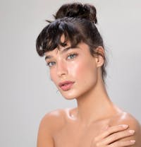 close up of woman with brown hair posing for camera