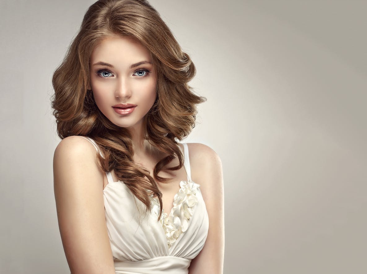 woman in a white dress posing for a picture