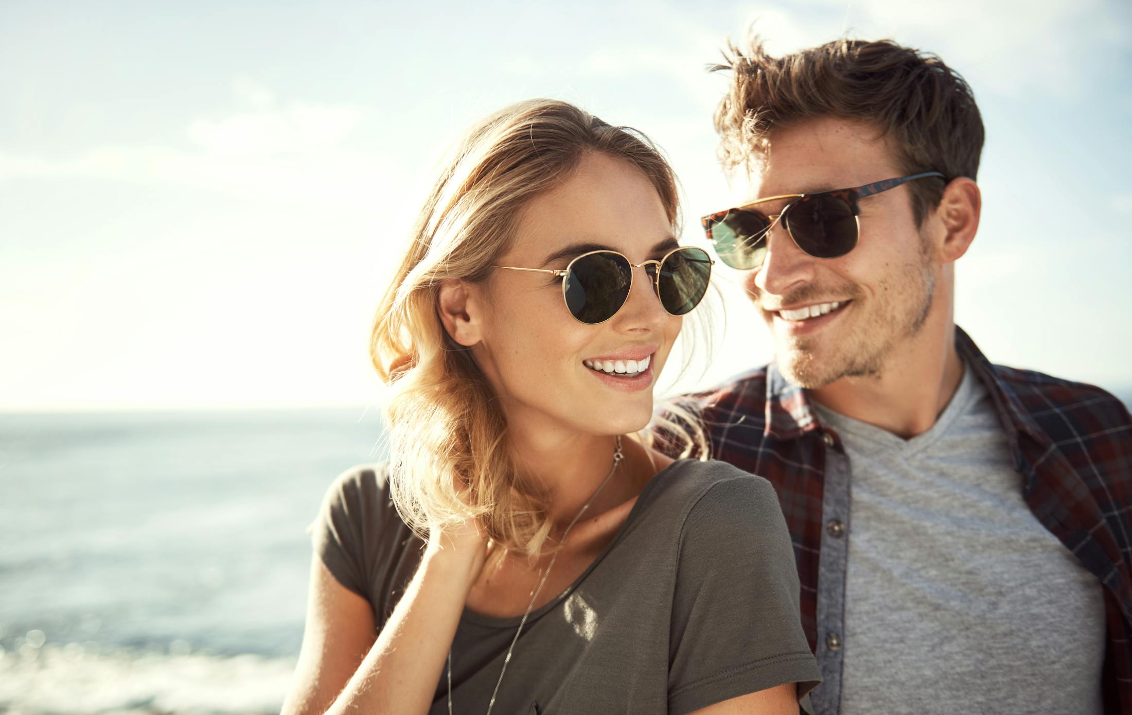 man and woman with sunglasses taking picture together