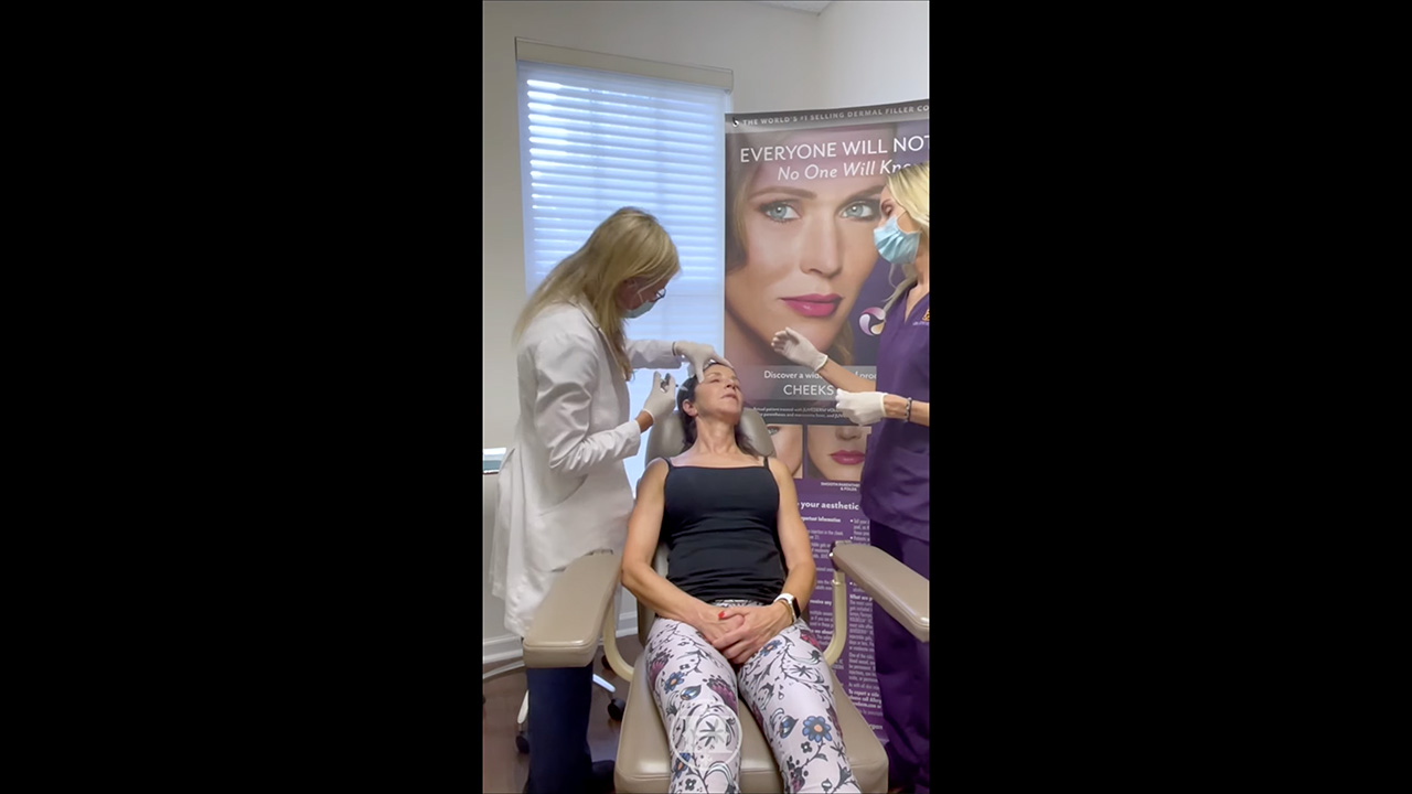 two blonde staff members working on a patient 2