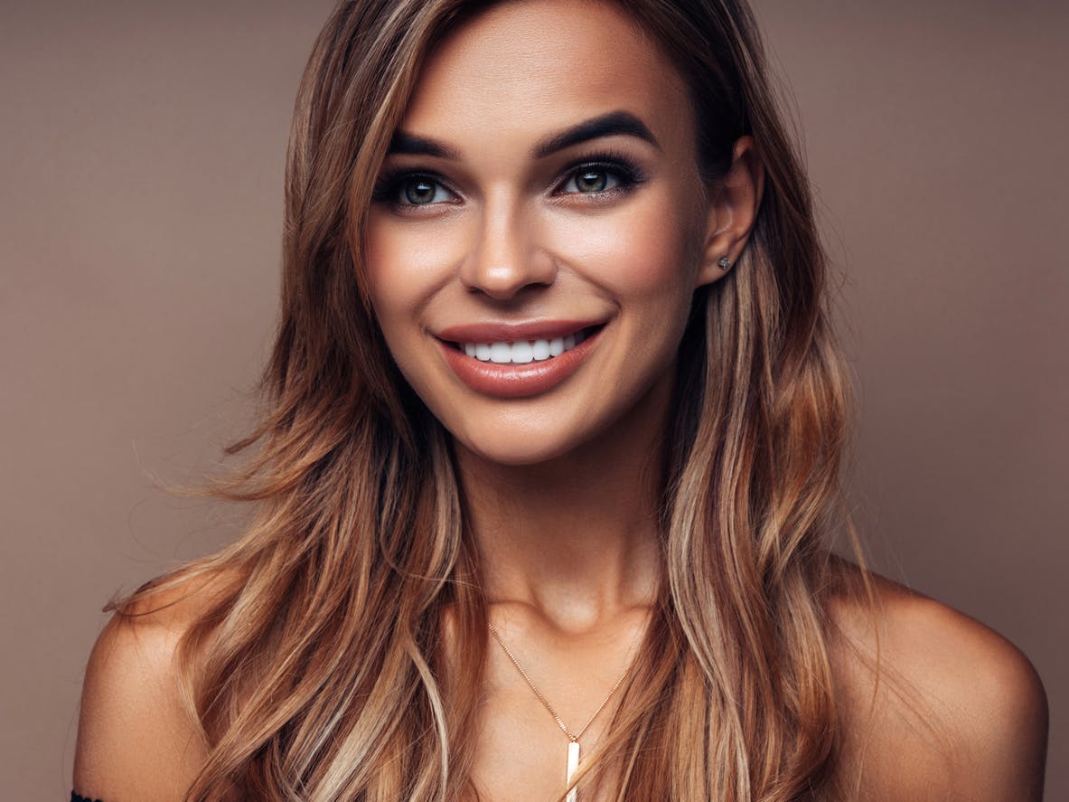 woman with long hair and a necklace on her neck