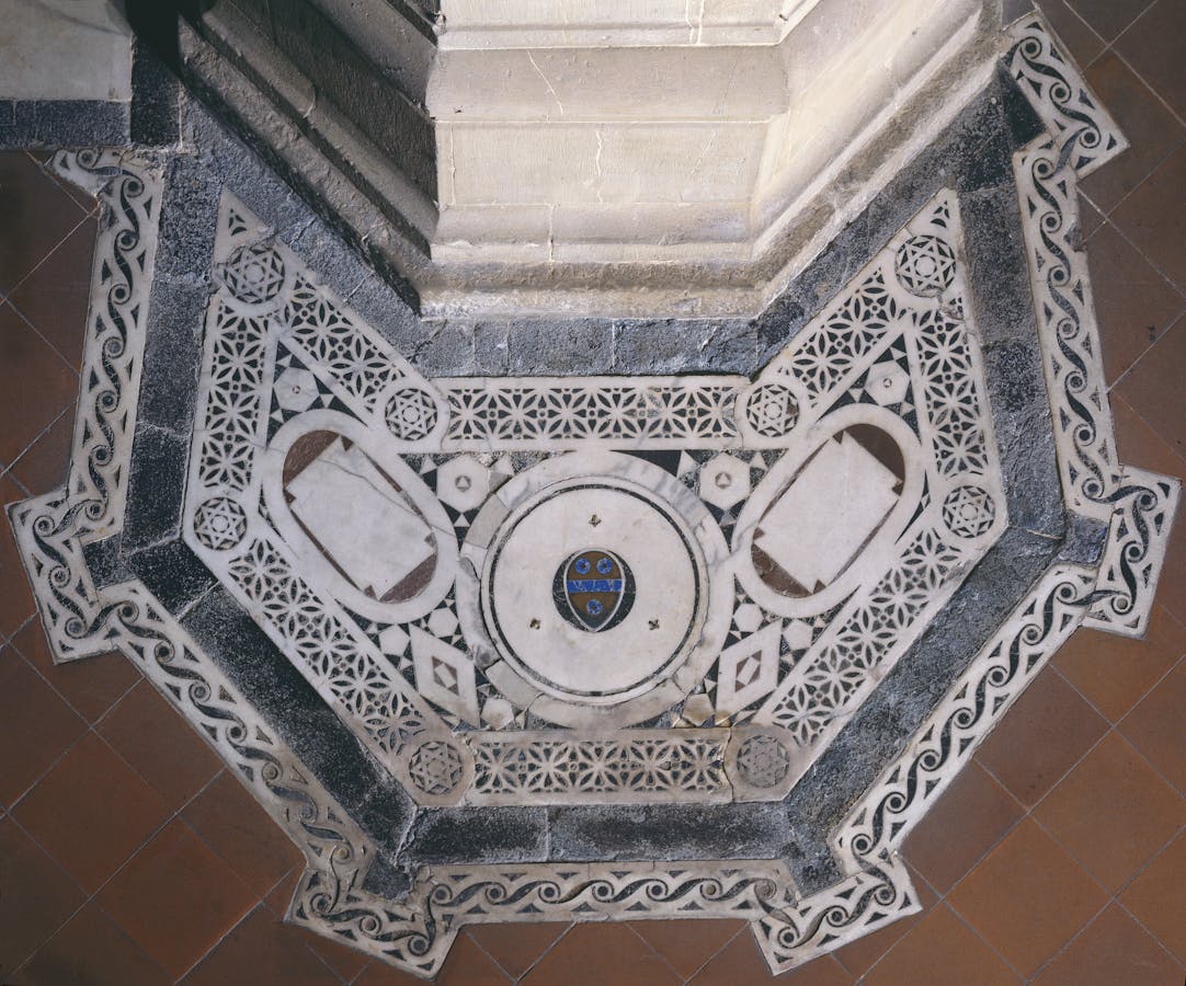 Mellini family tomb slab at the base of the pier against which the pulpit is built