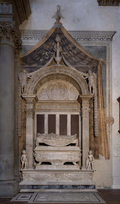 Desiderio da Settignano, “Tomba monumentale di Carlo Marsuppini”, 1454-1459, marmo e affresco. Firenze, Santa Croce, navata sinistra Desiderio da Settignano, “Tomba monumentale di Carlo Marsuppini”, 1454-1459, marmo e affresco. Firenze, Santa Croce, navata sinistra