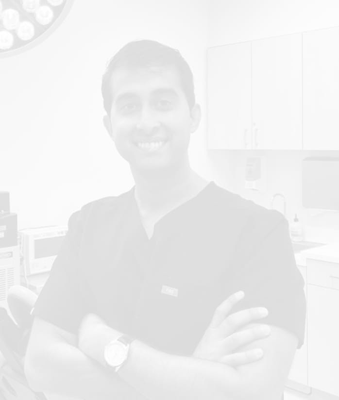 Cosmetic facial plastic surgeon, Dr Rana, smiling from patient room.