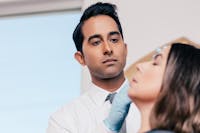 Dr. Rana using facial fillers on a female patient.