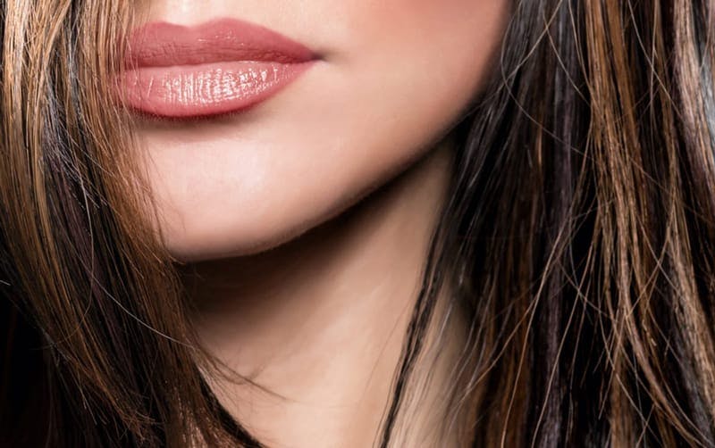 Woman's neck, sharp jaw line and full lips.
