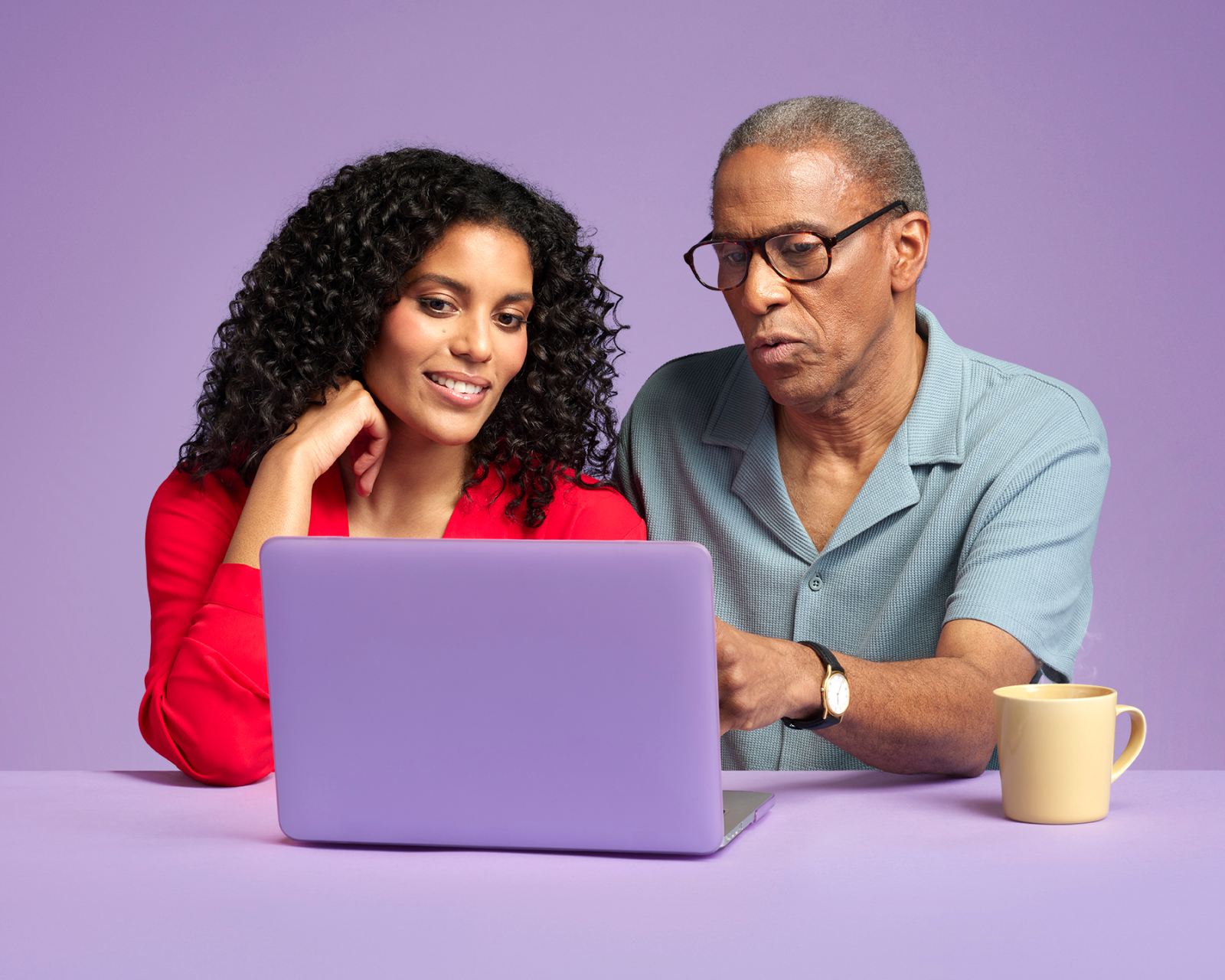 two people sat at a laptop