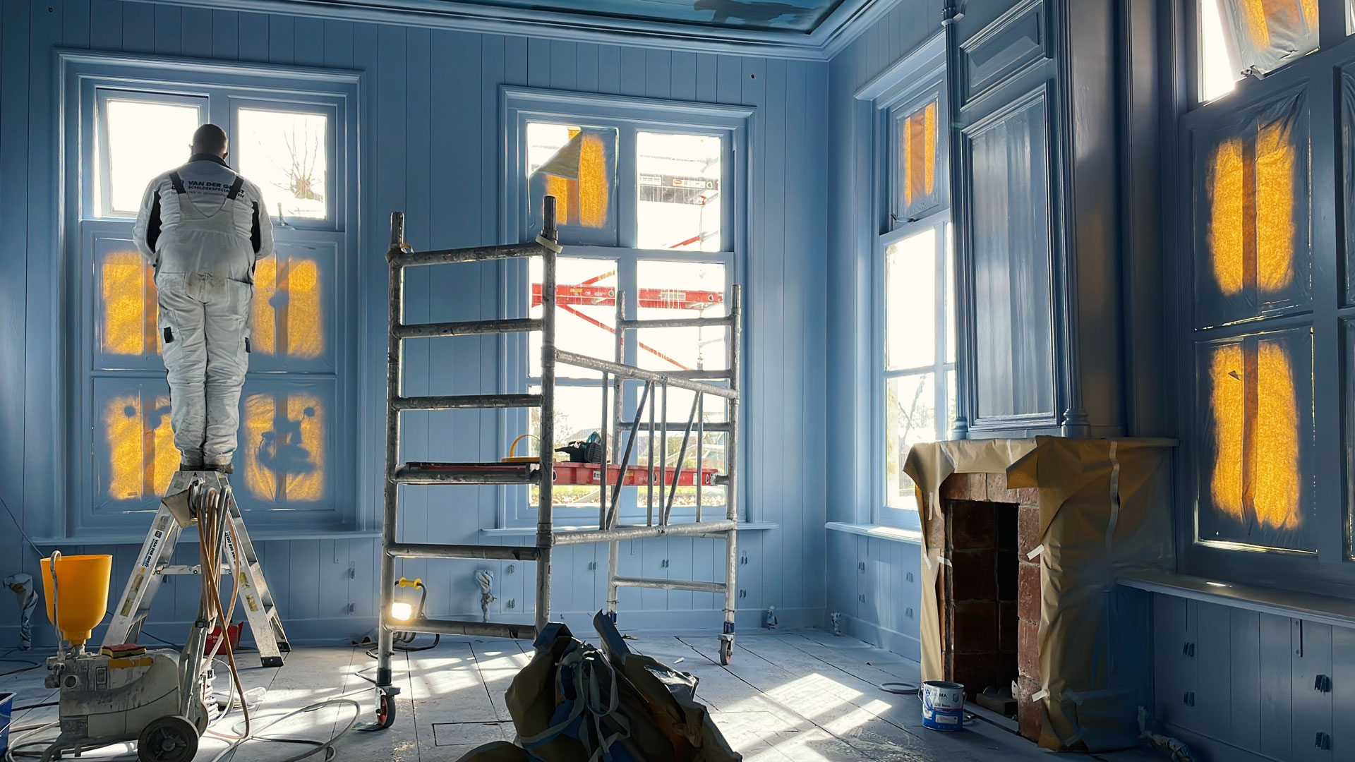 blue interior, view of painter at work