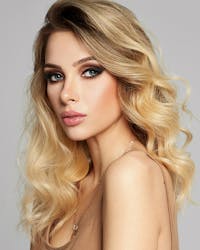 Glamorous woman with wavy hair and full makeup