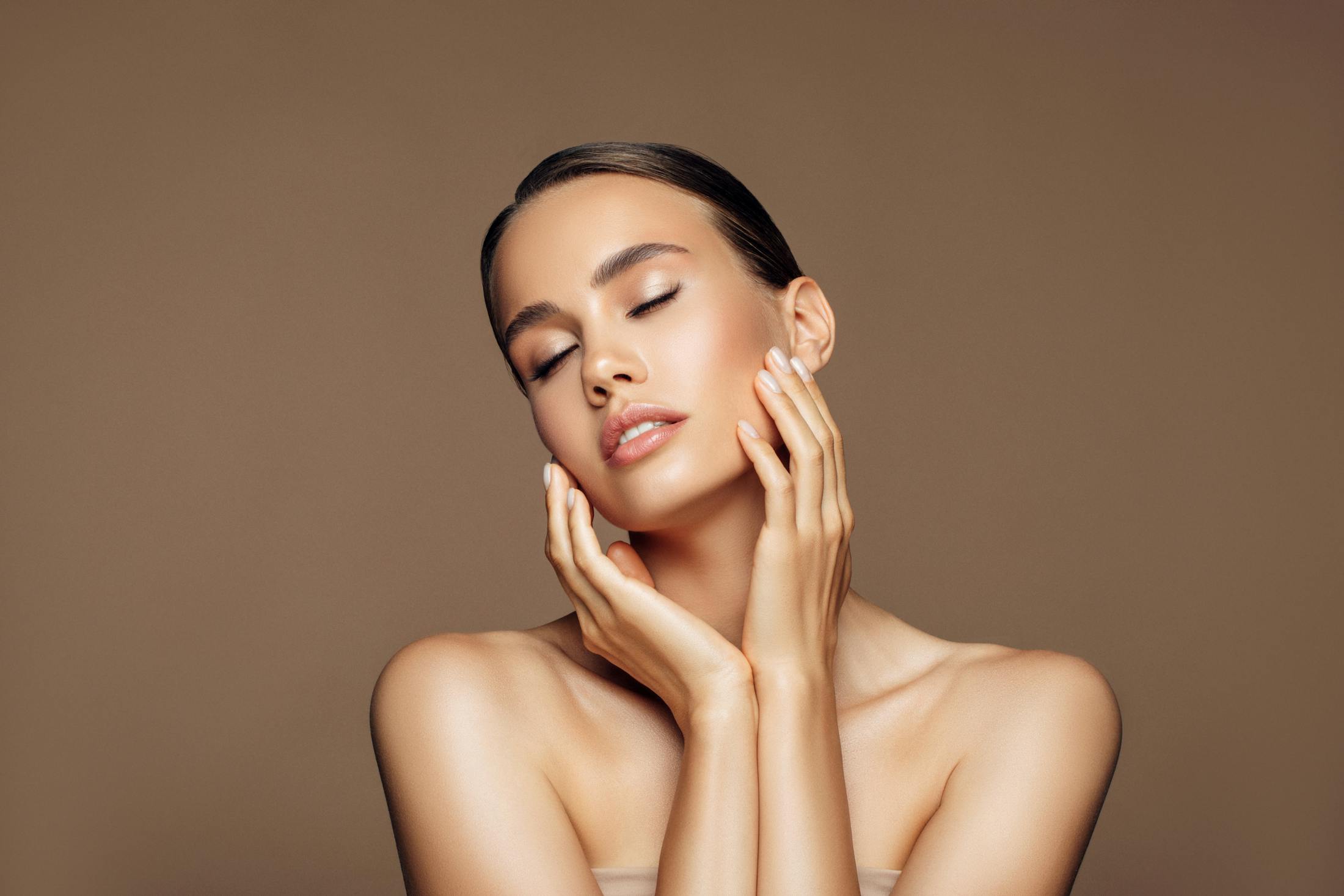 woman holding face with eyes closed