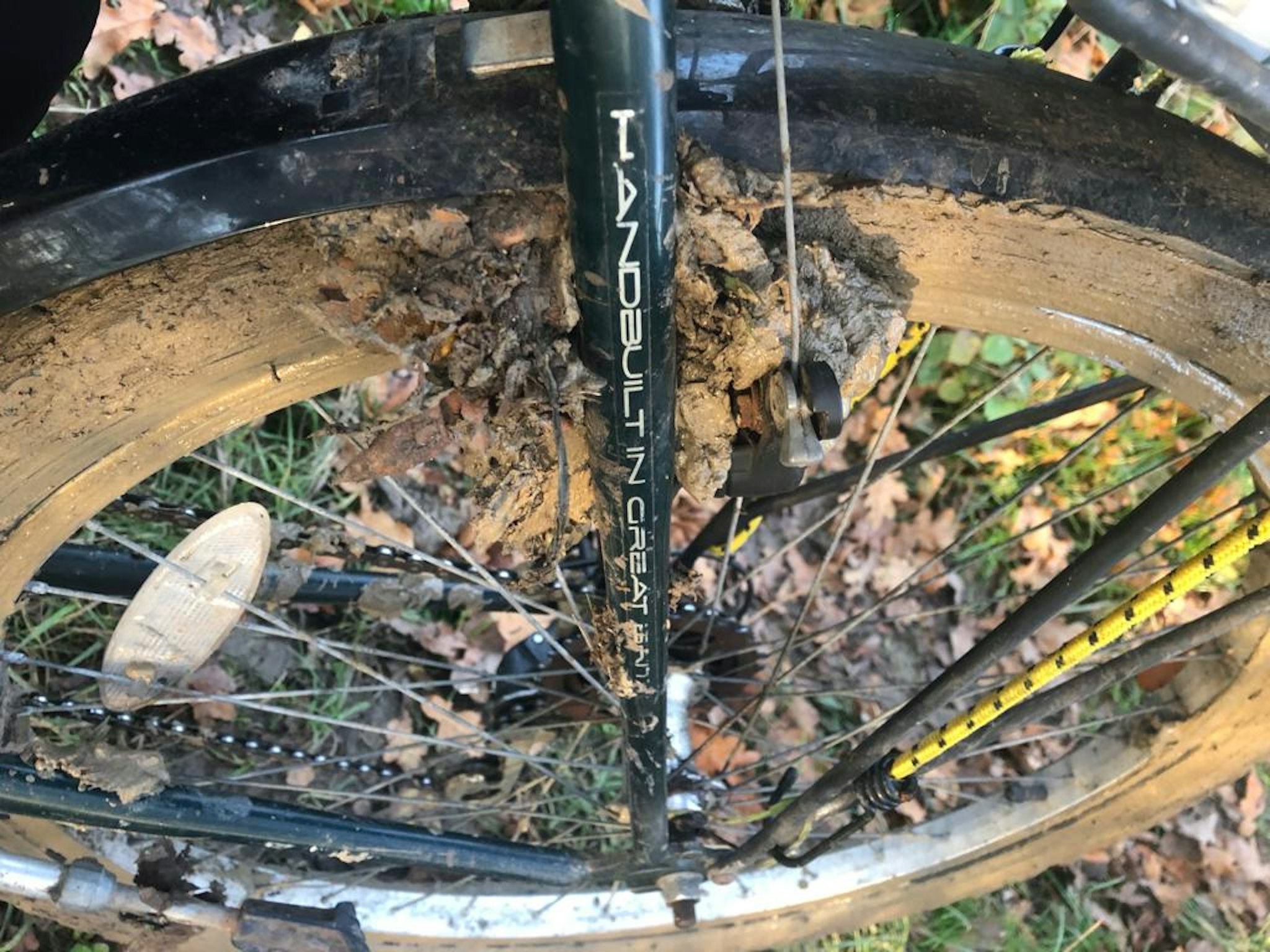 Bicycle fork with brakes clogged up with lots of mud