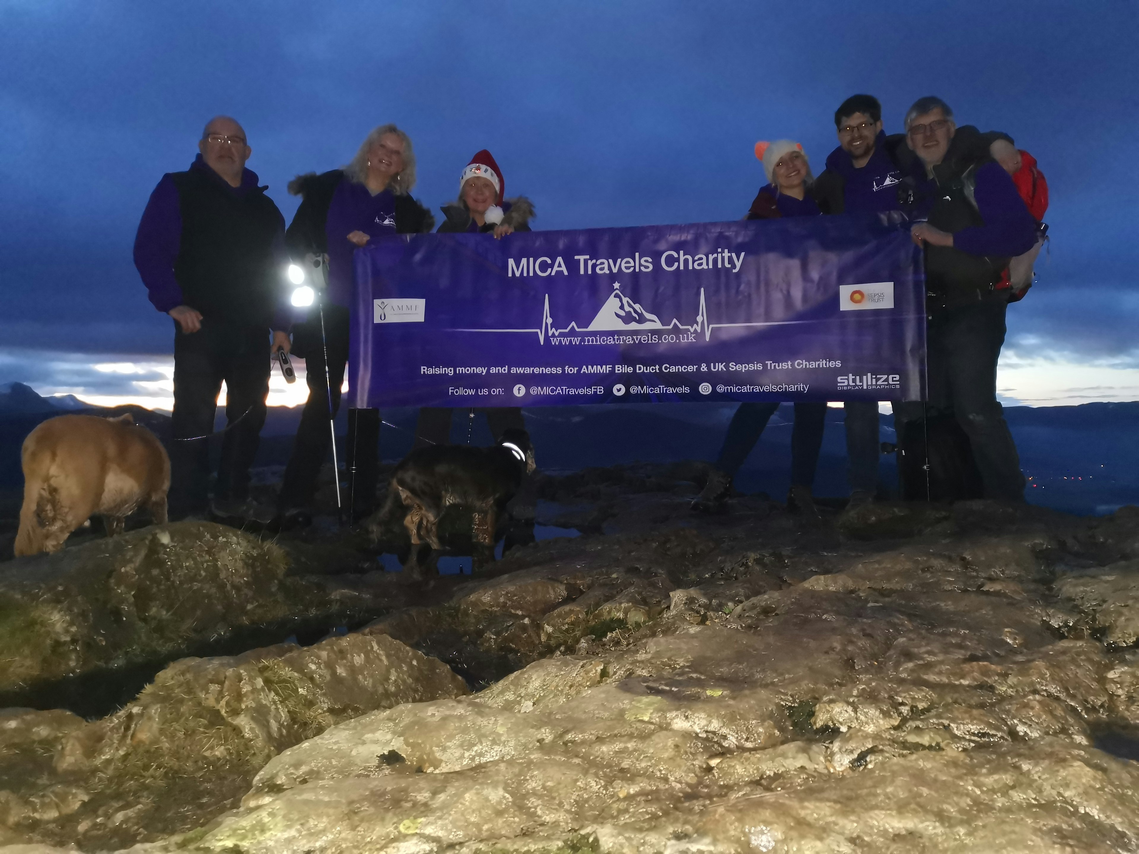 The MICA team holding a banner at the top