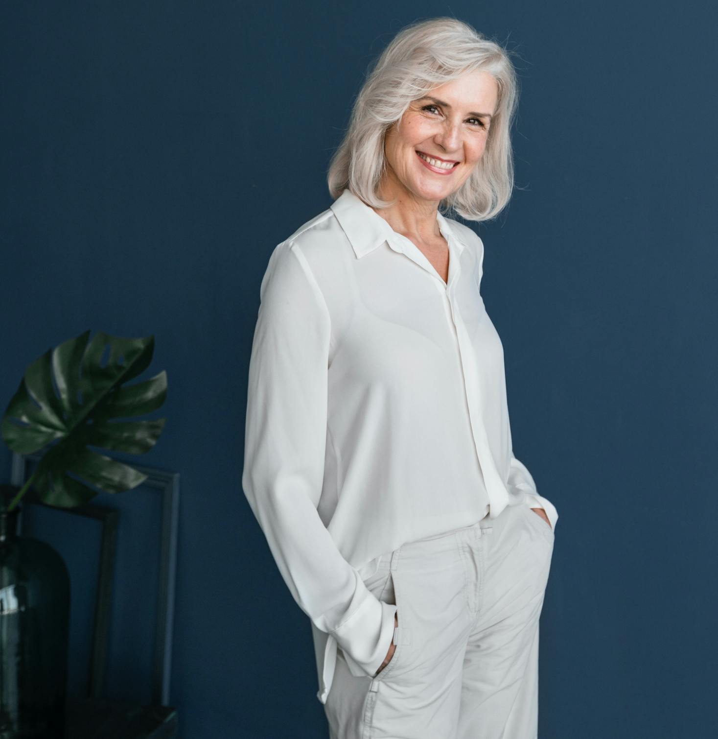 Older lady happily smiling and standing