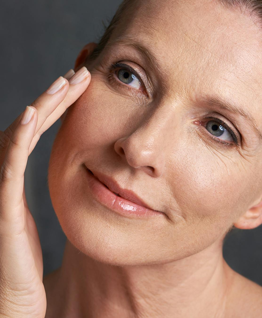 Older woman checking out her beautiful eyelids
